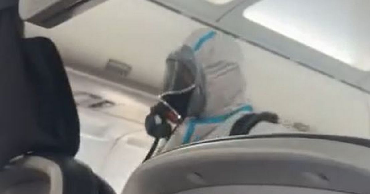Video shows moment hazmat-suited firemen swarm British Airways plane after passengers and staff 'collapse in the aisles'