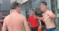 Moment bare-chested men fight in shopping centre as brawl breaks out
