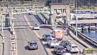 Suspect's car jumps gap of open drawbridge during high