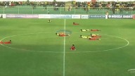 Football match stopped for bizarre reason as players and fans lie down on ground