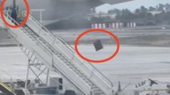 Spanish airport worker filmed hurling bags from plane like an Olympic athlete sparking outrage… but is all as it seems?