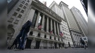 Wall Street edges back from its record heights