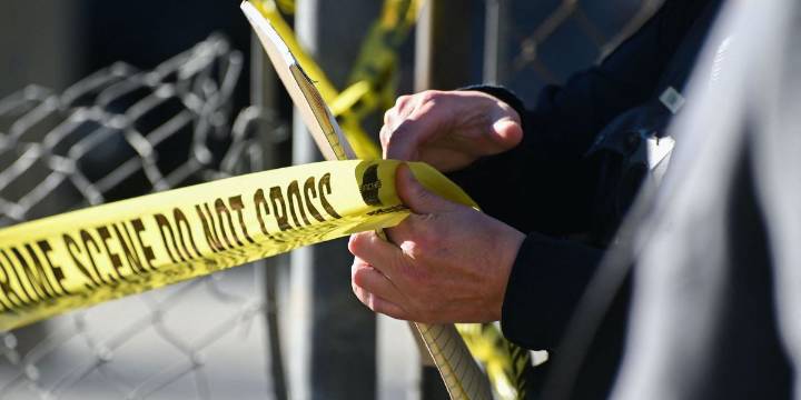 Man hacked off victim's head with machete while his wife and child watched, police say