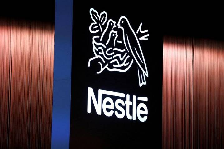 Nestle shares indicated slightly higher after chairman's early departure