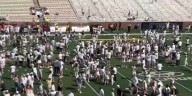 Georgia Tech celebrates by tossing goal posts into their president’s pool
