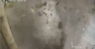 Horror CCTV shows moment stone roof collapses narrowly missing two pedestrians