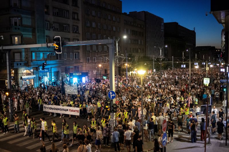 Tens of thousands march in Serbia's capital, demand snap vote