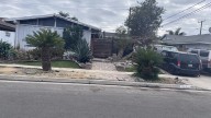 Group of neighbors help clear clutter outside Huntington Beach home after complaints