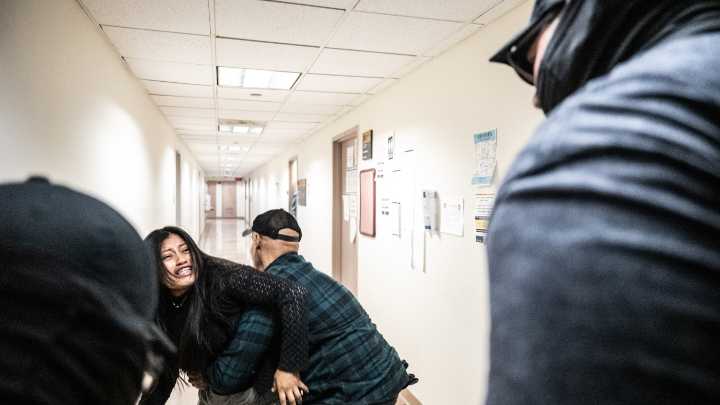 ICE officer caught on video pushing woman is placed on leave : NPR