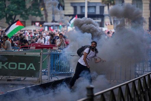 Chaotic scenes in Madrid as pro-Palestinian protesters disrupt final stage of Vuelta cycling race