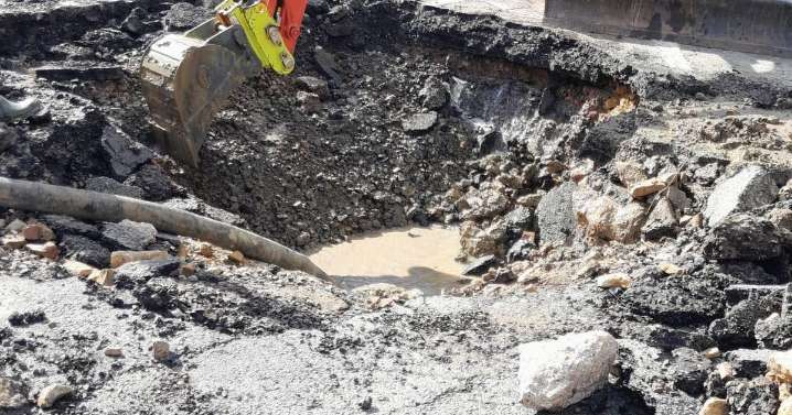 Part of main village road remains closed after water main burst