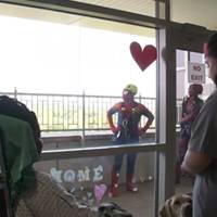 Superheroes show up to clean windows and bring smiles to the American Family Children's Hospital