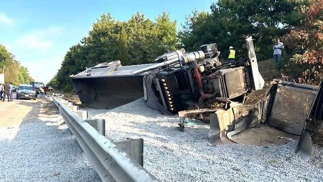Dump truck filled with gravel rolls over on Interstate 495