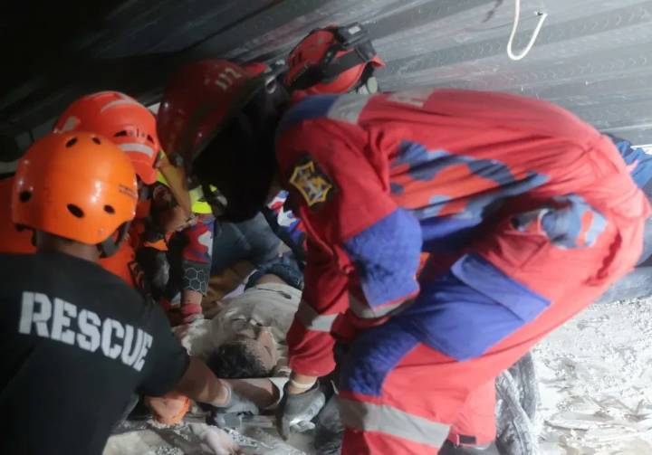 Rescuers run oxygen to survivors in Indonesia school building collapse that buried dozens