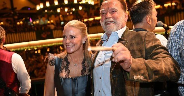 Schwarzenegger directs a band in a beer tent at Munich's Oktoberfest