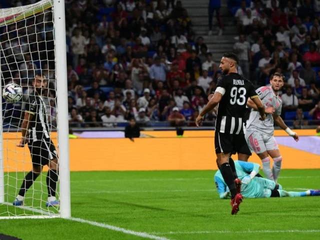 Cash-strapped Lyon win to climb level on top in France