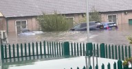 Flash flooding horror as cars submerged under water with 2 major flood alerts
