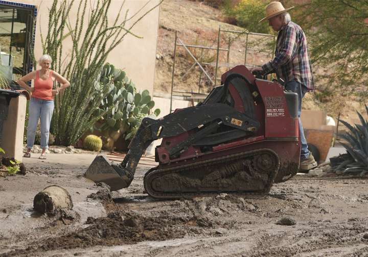 Mudslides trap drivers, bury roads and damage homes in Southern California