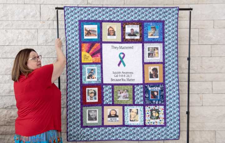‘Put faces to the statistics’: Survivors of Suicide Support Group displays quilt honoring family members who’ve died