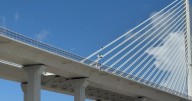 Man safe after climbing up cable of New Harbor Bridge Wednesday afternoon