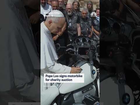 Pope Leo signs motorbike for charity auction