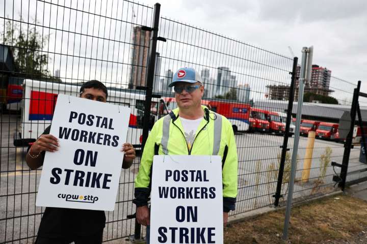 Postal workers walk the picket line in Surrey