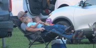 Families kick back for drive-in cinema surrounded by fields in Neligh