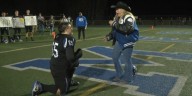 High school football player surprises girlfriend by proposing on field after senior night win