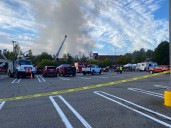 Fire departments are battling a blaze at an industrial building in Torrington
