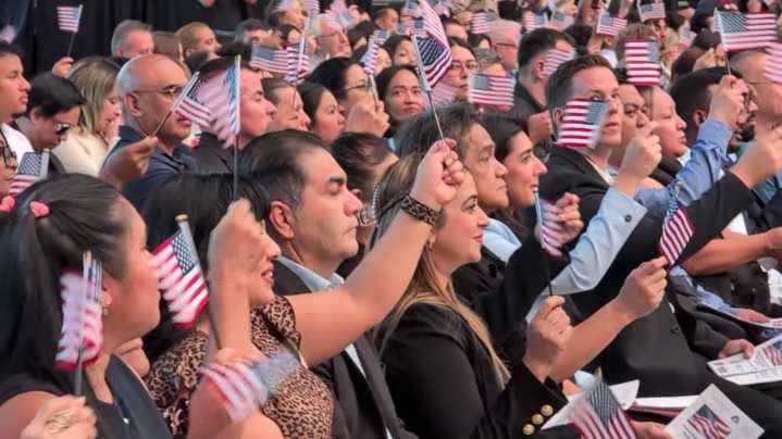 Las Vegas welcomes new immigrants in glitzy stadium ceremony