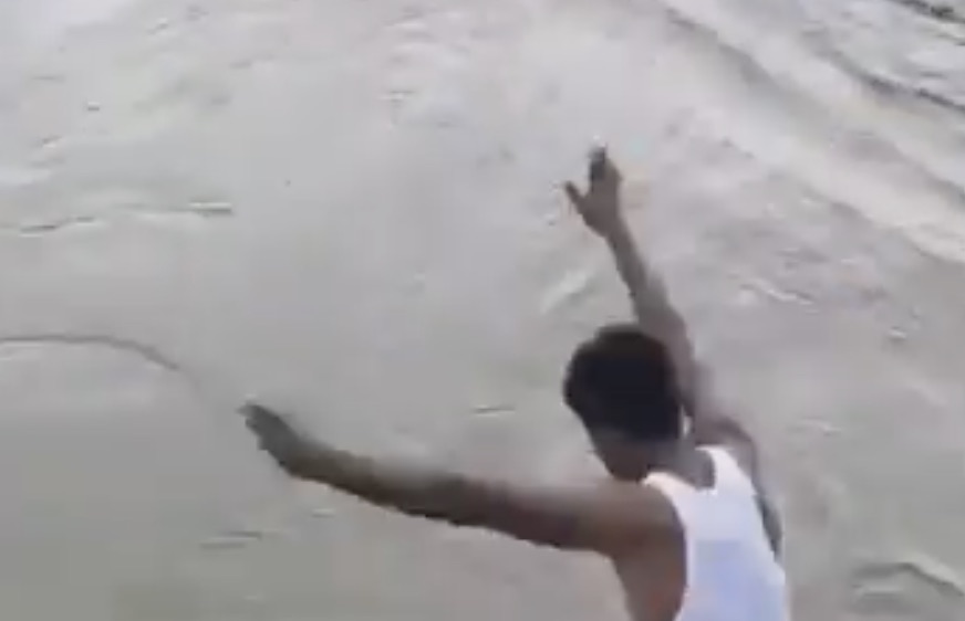 Horror moment social media daredevil leaps into raging river for a £4 bet