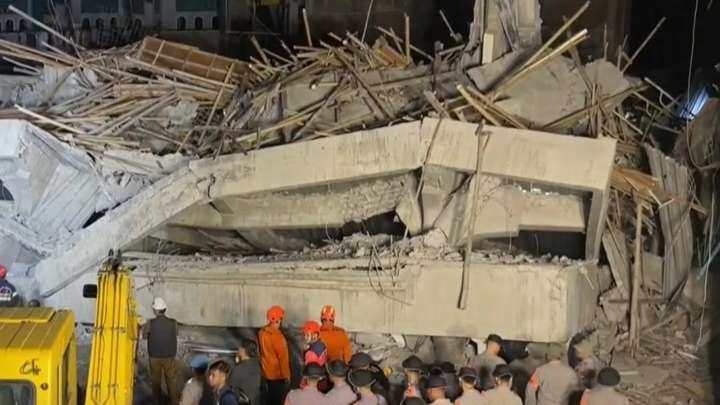 Rescuers run oxygen to survivors in Indonesia school building collapse that buried dozens