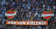 Banner held at MNUFC game reading "End Gun Violence" carries lineage to other school shootings