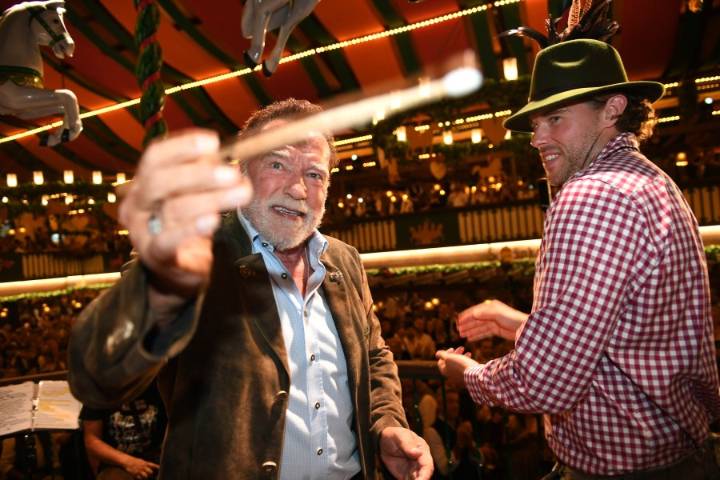 Schwarzenegger directs a band in a beer tent at Munich's Oktoberfest