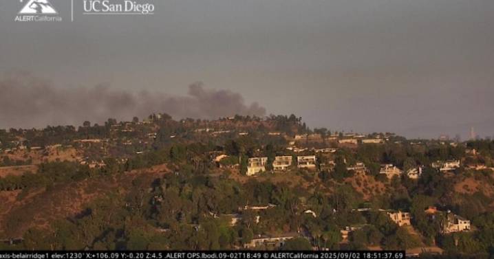 Brush fire burns in the Hollywood Hills,  threatening homes