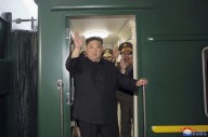 Kim Jong Un rides his trademark green train to China. He also has a plane, limos and white horses