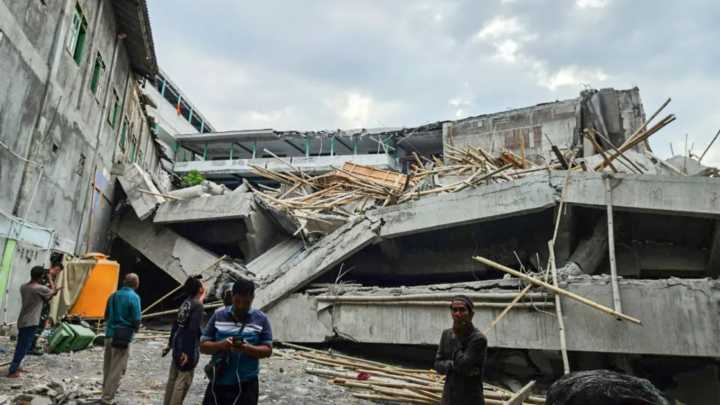 Frantic rescue as school collapses leaving at least one student dead and dozens trapped under the rubble in Indonesia