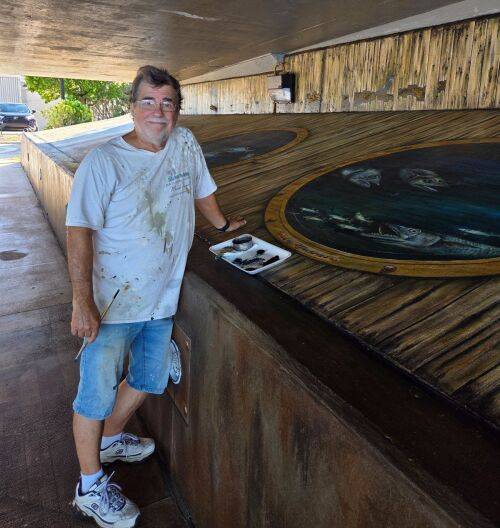 Sarasota artist Skip Dyrda restores 'Tails from the Harbor' mural in Punta Gorda