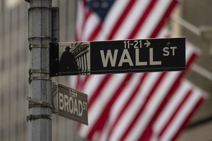 Canadian and U.S. stock markets down in late-morning trading, loonie also lower