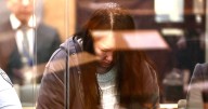Mum shakes head as she faces trial for killing kids and storing bodies in suitcases