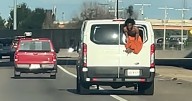 Video shows inmate hanging from rear window of Oklahoma prisoner transport van