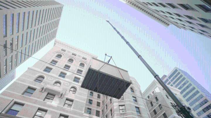 What was happening on 17th Street? Crane hoists 22,000-Ib boiler onto historic Denver building