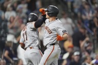 Chapman homers twice after appealing suspension to help the Giants beat the Rockies