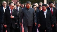 Xi Jinping  — flanked by Putin and Kim  — speaks of choice between war and peace at huge parade