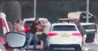 Woman drags motorist from car by their HAIR during 'road rage brawl' on motorway