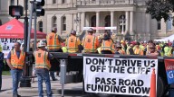 Workers rally for roads deal as lawmakers point fingers at each other