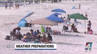 Dozens of people take in the waves at Jacksonville Beach as storms impact the coast
