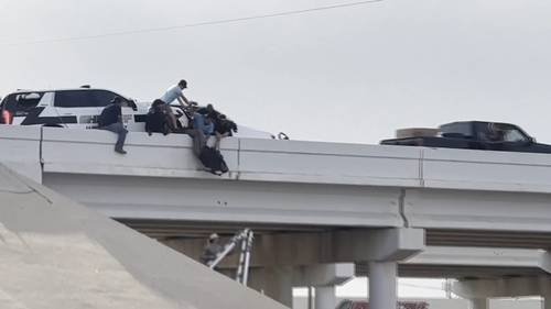 Deputy left dangling from Lubbock, Texas overpass after semi crashes into patrol unit, video shows rescue