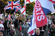What percentage of hotel rooms in Britain are occupied by migrants?