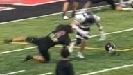 High school football star slammed after ripping rival's helmet off and striking him across head in shocking moment